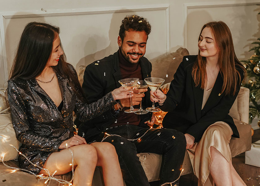 Three partygoers smiling